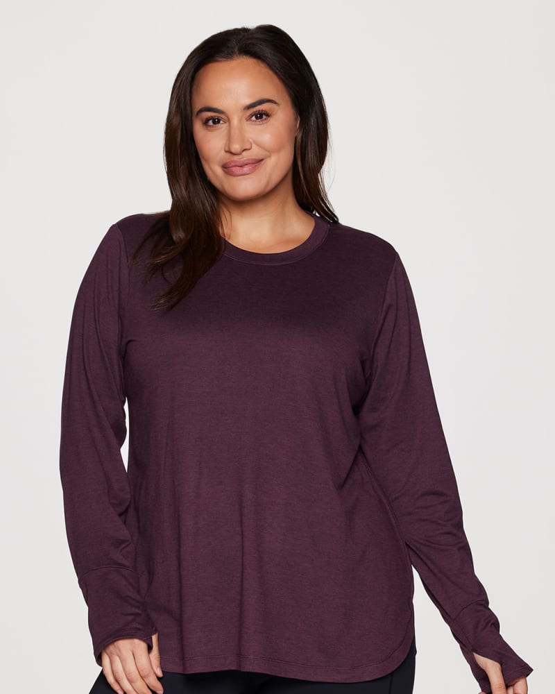 Front of a model wearing a size 2X Plus Studio Practice Long Sleeve Tunic Tee in Plum by RBX Active. | dia_product_style_image_id:316132